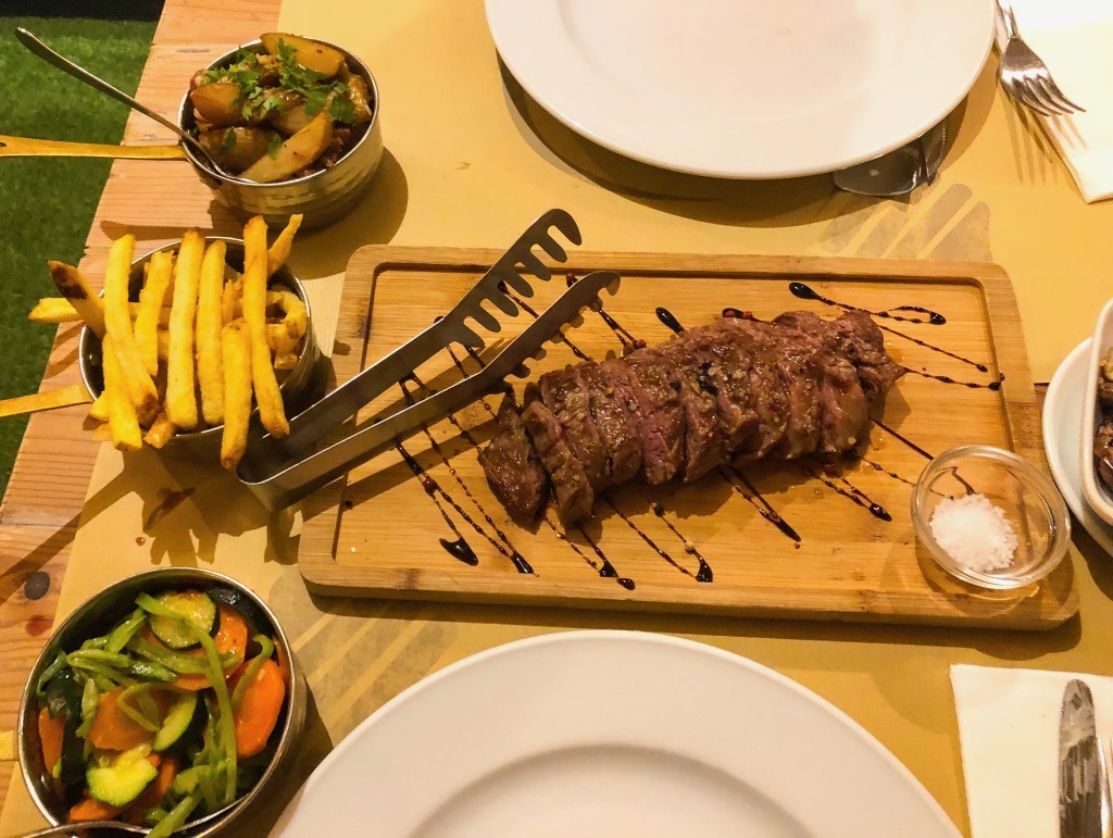 Steak, fries, potatoes, and vegetables from Tik Tapas