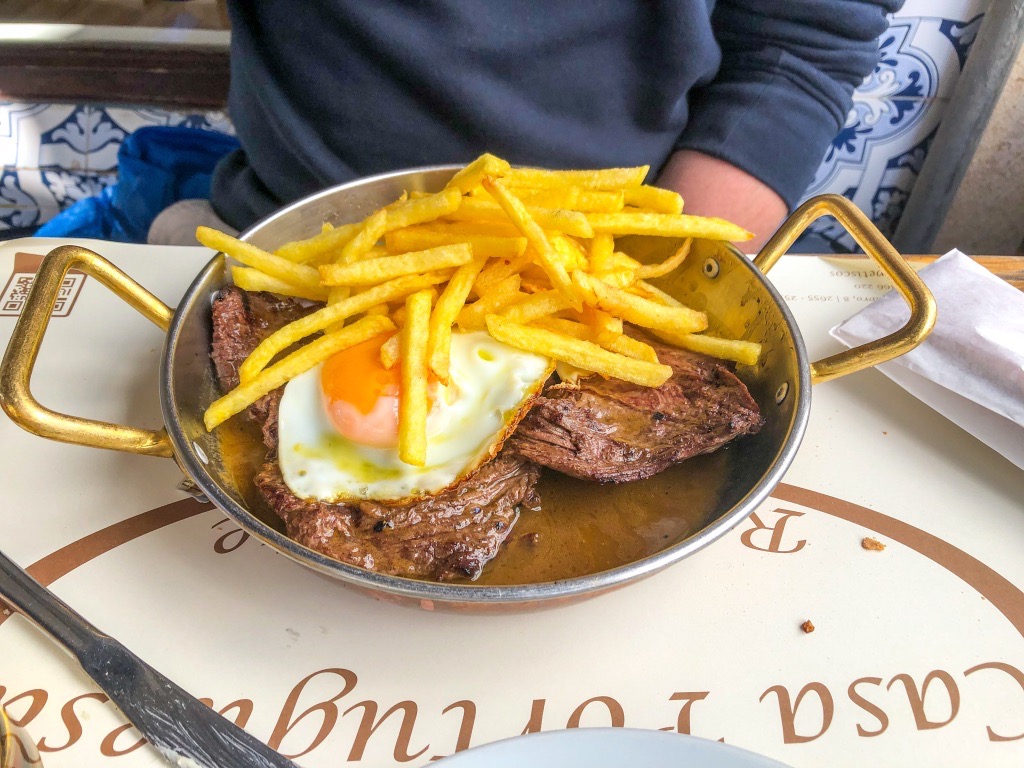 Traditional steak topped with a fried egg and fries from Casa Portuguesa