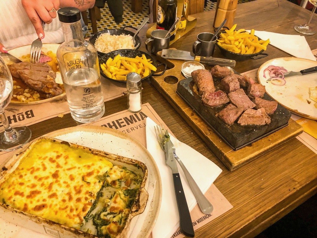 Steak, fries, and vegetarian lasagna from Pedra Dura Restaurant