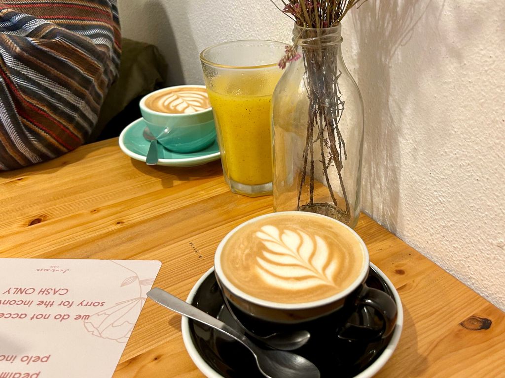 Two coffee mugs on an indoor table at Dear Rose Cafe Ericeira